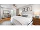 Cozy bedroom with hardwood floors, neutral colors, a ceiling fan, and dresser at 7409 Fiesta Way, Raleigh, NC 27615