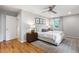 Bright bedroom features neutral decor, wood floors, and a ceiling fan at 7409 Fiesta Way, Raleigh, NC 27615