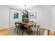 Bright dining room with hardwood floors, large window and modern lighting fixture at 7409 Fiesta Way, Raleigh, NC 27615