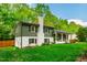 A beautifully landscaped home showcases its lush green lawn, fresh siding, and a white brick chimney at 7409 Fiesta Way, Raleigh, NC 27615