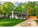 Well-maintained home with a lush lawn, complemented by green siding, a white chimney, and a private driveway at 7409 Fiesta Way, Raleigh, NC 27615