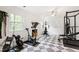 Spacious home gym with exercise equipment and checkerboard floors at 7409 Fiesta Way, Raleigh, NC 27615