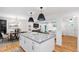 Open kitchen with a large island, flowing into the dining and living areas for easy entertaining and Gathering time at 7409 Fiesta Way, Raleigh, NC 27615