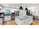 Modern kitchen with white cabinets, stainless steel appliances, granite countertops, and a large island at 7409 Fiesta Way, Raleigh, NC 27615
