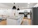 Bright kitchen with a central island, seamlessly connected to the living area, promoting an open and airy atmosphere at 7409 Fiesta Way, Raleigh, NC 27615