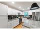 Modern kitchen with white cabinets, stainless steel appliances, granite countertops and updated fixtures at 7409 Fiesta Way, Raleigh, NC 27615
