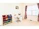 Comfortable bedroom with a cozy desk area near the window and playful storage for children at 743 Silver Stream Ln, Cary, NC 27519