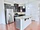 Modern kitchen featuring stainless steel appliances, a center island with sink, and dark wood cabinetry at 743 Silver Stream Ln, Cary, NC 27519