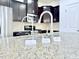 Close-up of kitchen with granite counters and stainless steel appliances at 743 Silver Stream Ln, Cary, NC 27519