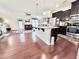 Open kitchen features a granite island, stainless steel appliances, and dark wood cabinets at 743 Silver Stream Ln, Cary, NC 27519