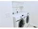 Laundry room equipped with modern Samsung washer and dryer, perfect for efficient chores at 743 Silver Stream Ln, Cary, NC 27519