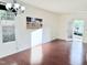 Bright living room with hardwood floors, stylish light fixture and access to outdoor space at 743 Silver Stream Ln, Cary, NC 27519