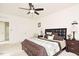 Main bedroom featuring ceiling fan, decorative bedding, and side table lamps at 743 Silver Stream Ln, Cary, NC 27519