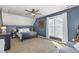 Cozy bedroom with ample sunlight, a ceiling fan, and dark blue accent wall at 756 Rockville Rd, Wake Forest, NC 27587