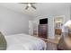 Bedroom showcasing neutral tones, a ceiling fan, large dresser with TV and view to ensuite bathroom at 756 Rockville Rd, Wake Forest, NC 27587