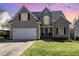Charming two-story home featuring a well-manicured lawn and a two-car garage at 756 Rockville Rd, Wake Forest, NC 27587