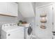 Bright laundry room features a Whirlpool washer and Samsung dryer, plus extra storage at 756 Rockville Rd, Wake Forest, NC 27587