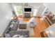 Open living room with hardwood floors, fireplace, ceiling fan, comfortable seating, and abundant natural light at 756 Rockville Rd, Wake Forest, NC 27587
