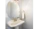 Charming powder room featuring a pedestal sink, brushed nickel faucet and a round mirror with decorative lighting at 756 Rockville Rd, Wake Forest, NC 27587