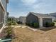 View of backyard with detached garage and neighboring homes at 781 Cormiche Ln, Wake Forest, NC 27587