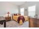Comfortable bedroom with neutral colors, a plush bed, and natural light from two windows at 781 Cormiche Ln, Wake Forest, NC 27587