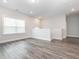 Upstairs bonus room with wood flooring and a large window at 781 Cormiche Ln, Wake Forest, NC 27587