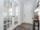 Stylish entryway featuring wood floors, neutral walls, and beautiful glass paneled doors at 781 Cormiche Ln, Wake Forest, NC 27587