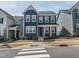Charming blue two-story home featuring a covered front porch and well-manicured landscaping at 781 Cormiche Ln, Wake Forest, NC 27587