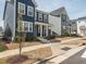 Attractive neighborhood street view showing the blue two-story home with classic curb appeal at 781 Cormiche Ln, Wake Forest, NC 27587