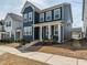 Charming blue two-story home featuring a covered front porch with lovely curb appeal at 781 Cormiche Ln, Wake Forest, NC 27587