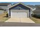 View of a one car detached garage with blue siding at 781 Cormiche Ln, Wake Forest, NC 27587