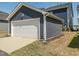 View of a one car detached garage with blue siding at 781 Cormiche Ln, Wake Forest, NC 27587