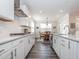 Well-lit kitchen showcasing stainless appliances, subway tile, and dining area at 781 Cormiche Ln, Wake Forest, NC 27587