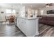 Kitchen island offers bar seating and an open floor plan with wood floors to living and dining areas at 781 Cormiche Ln, Wake Forest, NC 27587