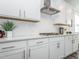 Bright kitchen features white cabinets, subway tile backsplash, stainless hood, and quartz countertops at 781 Cormiche Ln, Wake Forest, NC 27587