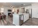 Open-concept kitchen with stainless steel appliances, a center island, and seamless flow into the living area at 781 Cormiche Ln, Wake Forest, NC 27587