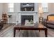 Comfortable living room with a fireplace, large TV, and cozy leather furniture, perfect for relaxation at 781 Cormiche Ln, Wake Forest, NC 27587