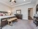 Spacious primary bedroom with large bed, lots of furniture, and doorway leading to another room at 781 Cormiche Ln, Wake Forest, NC 27587