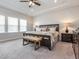 Spacious main bedroom with tray ceilings, large bed, and natural light from the large windows at 781 Cormiche Ln, Wake Forest, NC 27587