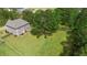 Expansive backyard featuring a lush lawn, mature trees, and a wooden fence, perfect for outdoor enjoyment at 8016 Parker Mill Trl, Fuquay Varina, NC 27526