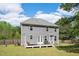 Backyard view of the home with a deck area and a well-maintained lawn at 8016 Parker Mill Trl, Fuquay Varina, NC 27526