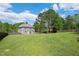 Spacious backyard with a well-maintained lawn and a view of the home's rear exterior at 8016 Parker Mill Trl, Fuquay Varina, NC 27526