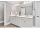 Bright bathroom boasts double sinks, white cabinetry, a large mirror, and stylish fixtures at 8016 Parker Mill Trl, Fuquay Varina, NC 27526