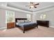 Inviting bedroom with a tray ceiling, large windows, and ample natural light at 8016 Parker Mill Trl, Fuquay Varina, NC 27526