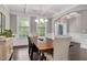 Open dining room featuring bright windows, hardwood flooring, and coffered ceilings at 8016 Parker Mill Trl, Fuquay Varina, NC 27526