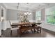 Elegant dining room with coffered ceilings, hardwood floors, a large table, and ample natural light at 8016 Parker Mill Trl, Fuquay Varina, NC 27526