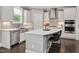 Bright kitchen featuring white cabinets, stainless steel appliances, and an island with seating at 8016 Parker Mill Trl, Fuquay Varina, NC 27526