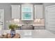 Well-lit kitchen featuring stainless steel appliances, light countertops, and ample cabinet space at 8016 Parker Mill Trl, Fuquay Varina, NC 27526