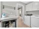 Laundry room with washer and dryer, drying rack, counter, and laundry sorter at 8016 Parker Mill Trl, Fuquay Varina, NC 27526