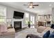 Bright living room with a fireplace, large windows, and an open floor plan at 8016 Parker Mill Trl, Fuquay Varina, NC 27526